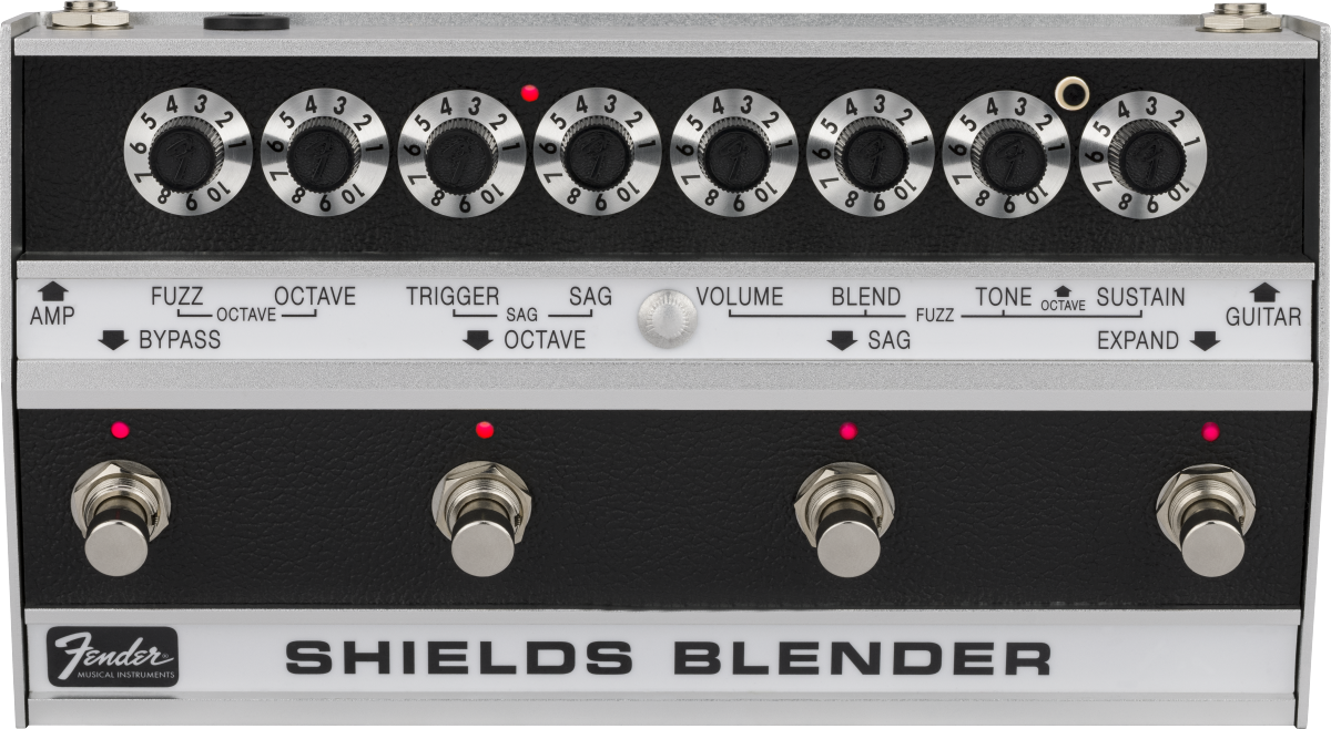 The image shows a vintage Fender Shields Blender guitar effects pedal from the late 1960s/early 1970s. It features eight labeled rotary knobs controlling fuzz, octave, trigger, sag, volume, blend, tone, and sustain. The bottom section has four footswitches with red LEDs for selecting effects modes. The Fender logo and "SHIELDS BLENDER" branding are visible. This multi-effects unit blends sounds and is now a rare collectible.