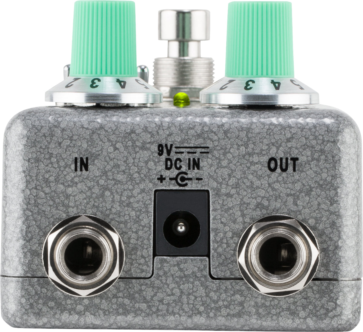 The image shows a guitar effects pedal with a compact, rectangular metal enclosure in speckled gray. It features two 1/4" jacks labeled "IN" and "OUT," a "9V DC IN" power input, two mint green control knobs, a chrome footswitch, and a small LED indicator. This pedal modifies guitar or bass sounds by processing the signal between the instrument and amplifier.