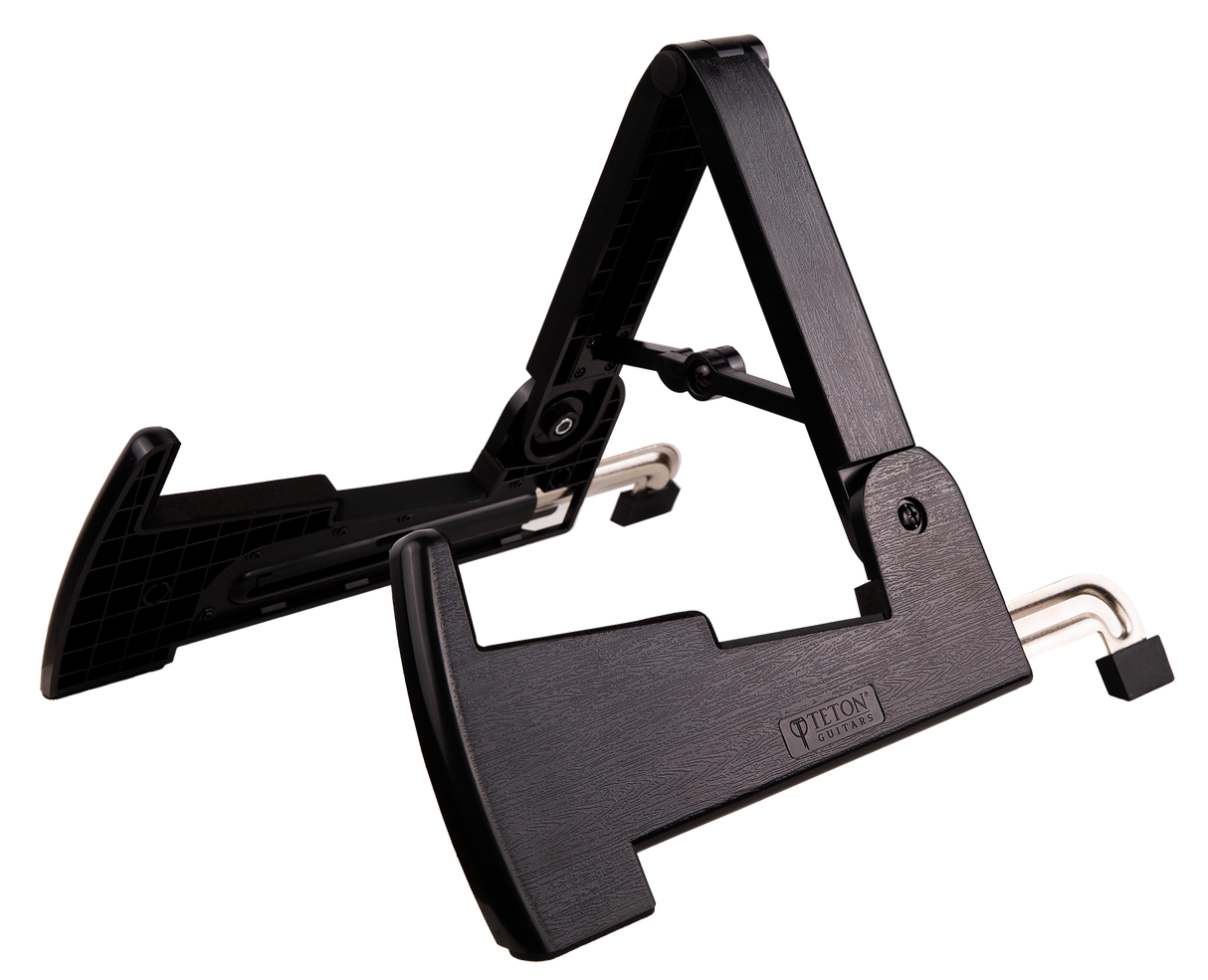 The image shows a folding A-frame guitar stand made of black metal with a dark wood-grain finish, branded "Teton Edition." It has adjustable, foldable legs, padded contact points, and supports various guitar types. Designed for stability and portability, it is suitable for home, stage, or studio use, providing safe and convenient guitar storage and transport.