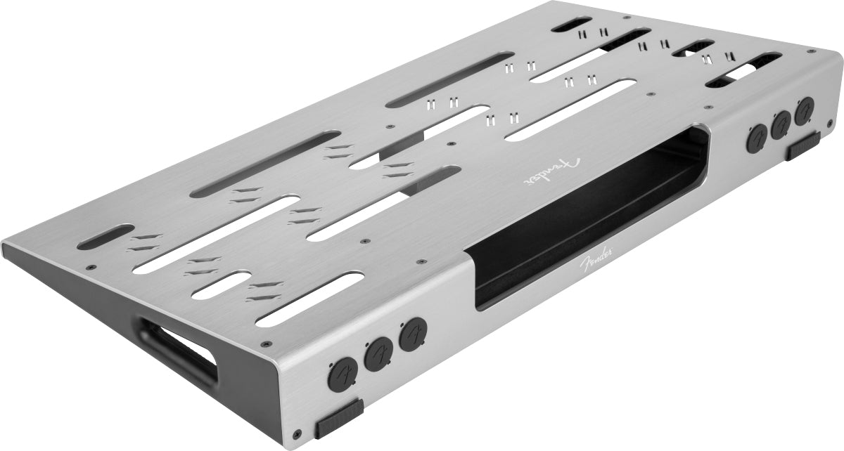 The image shows a Fender-branded pedalboard with a silver aluminum frame featuring multiple slots for mounting guitar effects pedals. It includes cable management channels, rubber feet for stability, and a modular design for customizable setups. Built with professional-grade quality, it offers an organized, portable platform ideal for electric guitarists in both studio and live settings.