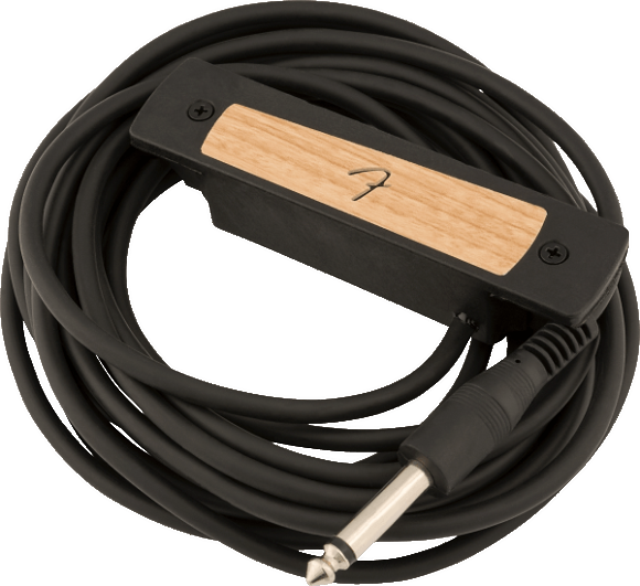 The image shows an acoustic guitar soundhole pickup with a wooden top featuring a curved design, housed in a black mounting frame with visible screws. A long black cable with a 1/4" instrument jack extends from the pickup. This device converts string vibrations into electrical signals, allowing acoustic guitars to be amplified while maintaining a natural wood aesthetic.
