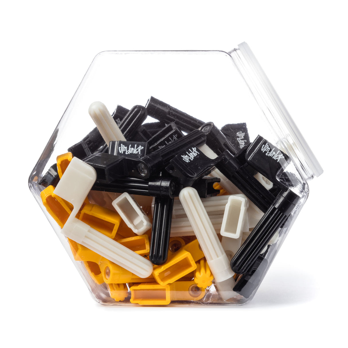 A plastic jar filled with Jim Dunlop guitar string winders in mixed colors on a white background