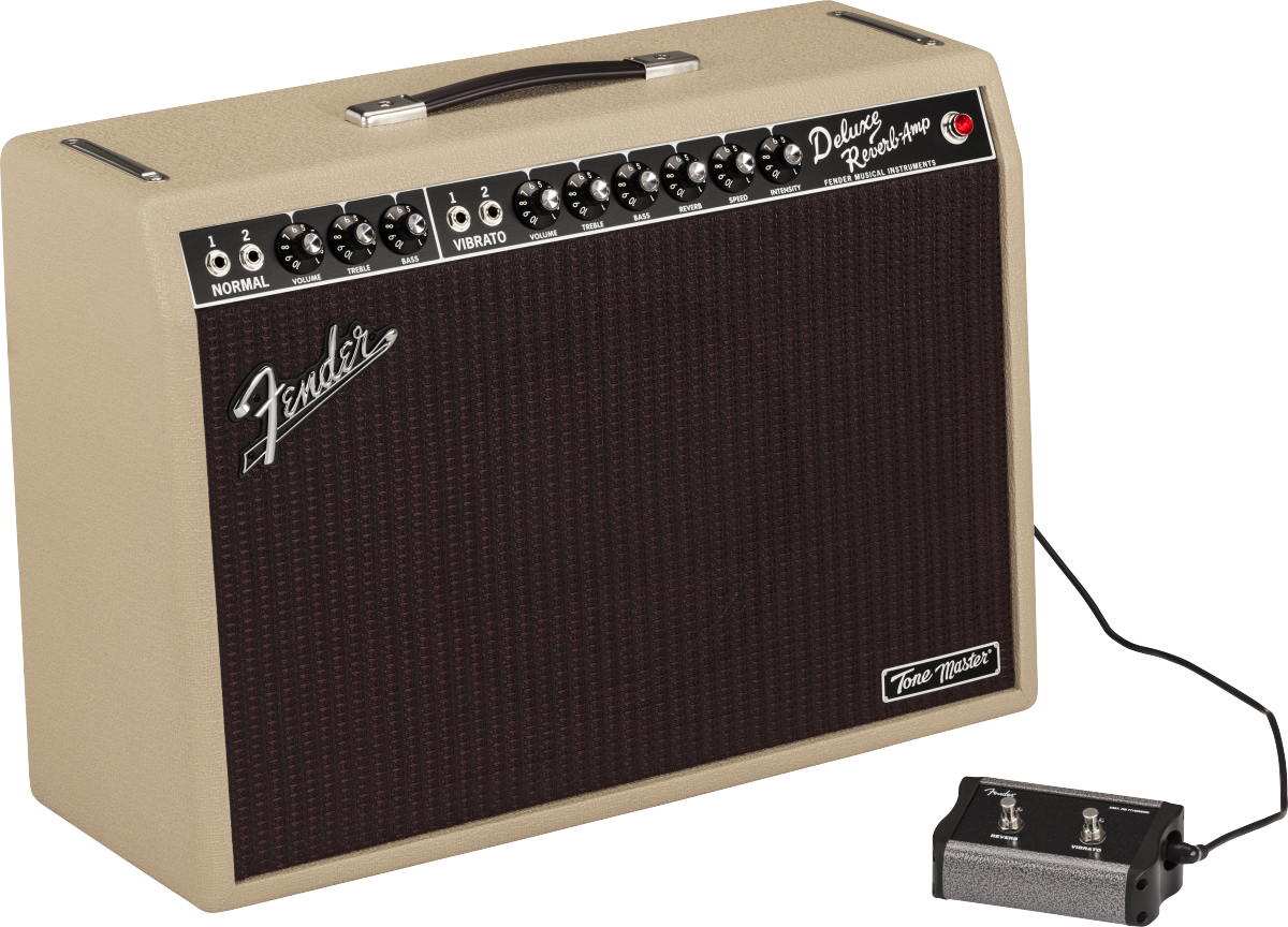 The image shows a Fender Deluxe Reverb-Amp guitar amplifier with a blonde/cream tolex exterior and dark brown grille. The control panel features multiple knobs for volume, treble, bass, reverb, and vibrato, with two input jacks labeled "NORMAL." A black footswitch is connected, and a black leather handle is on top. The "Tone Master" badge is visible on the lower right. This classic tube combo amp is known for its warm tone and built-in spring reverb.