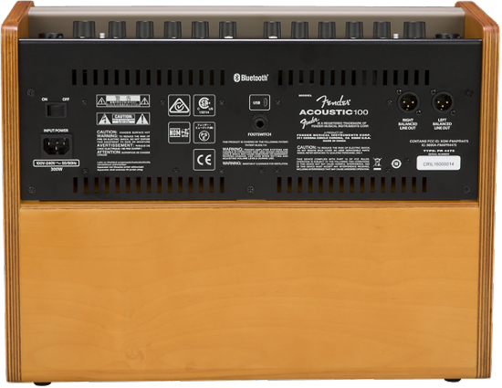 The image shows the back panel of an Orange Acoustic Crush 100 guitar amplifier. It features the signature orange/tan cabinet, black control panel, and model label. Visible are Bluetooth connectivity, multiple inputs/outputs including XLR and audio jacks, power connections, ventilation slots, safety certifications, and a wooden cabinet. This solid-state amp is designed for acoustic guitars and delivers 100 watts, suitable for live use.