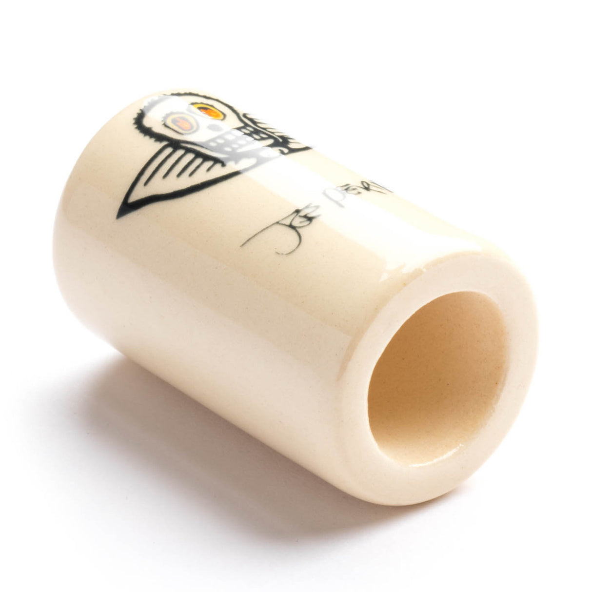 A white ceramic guitar slide with skull design on a white background