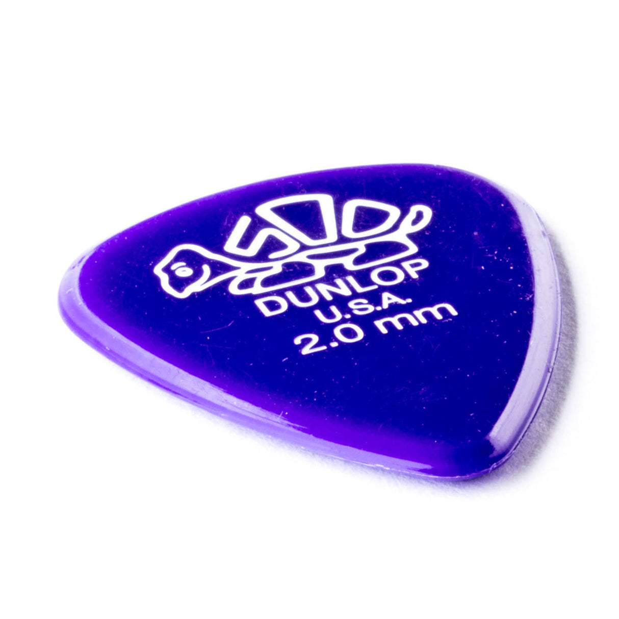A purple 'Dunlop' branded guitar pick with a turtle design on a white background
