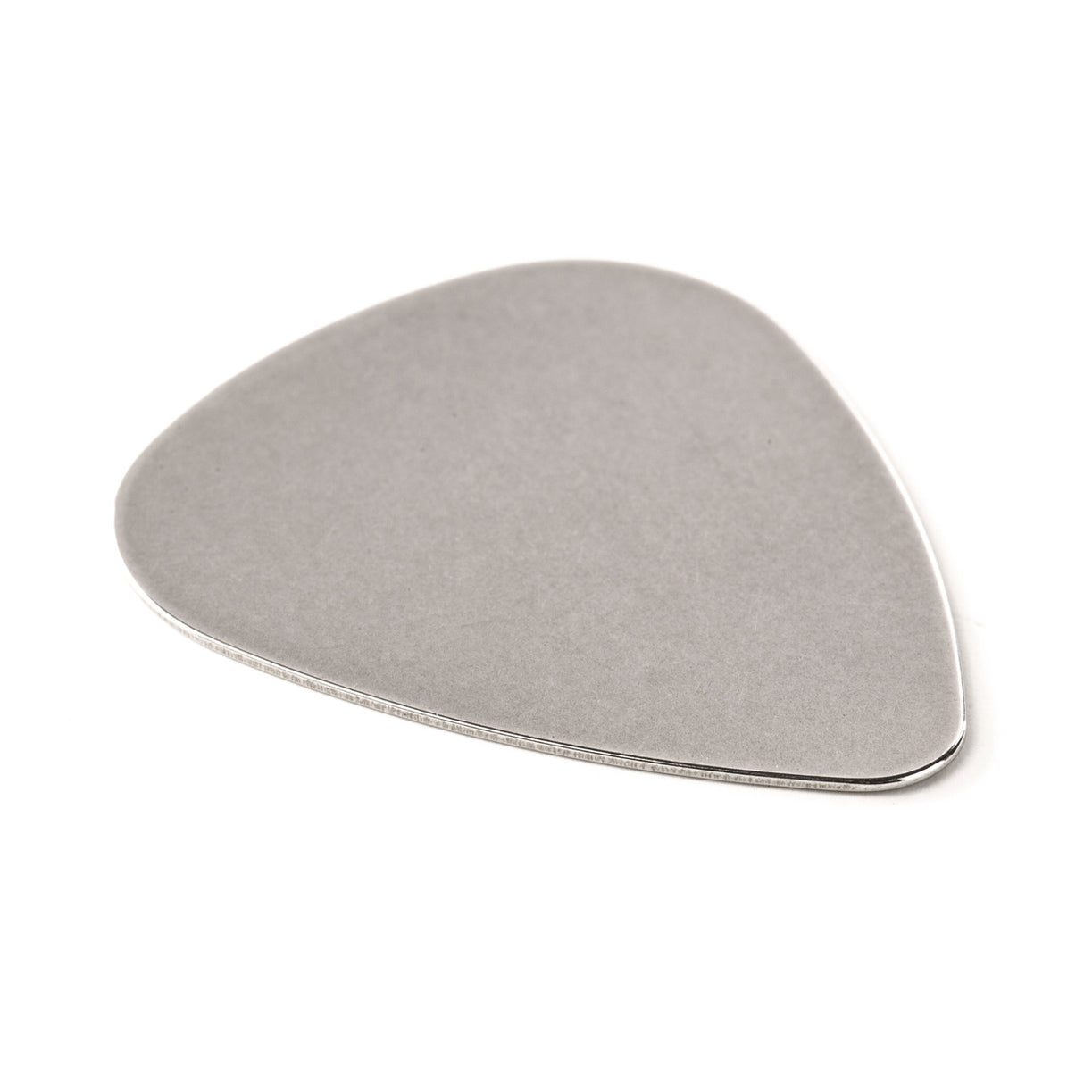 A stainless steel guitar pick on a white background