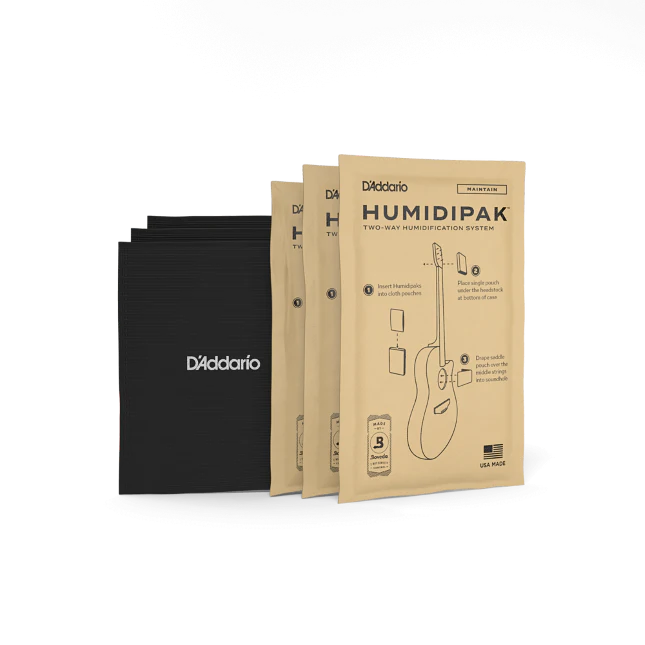 The image shows three kraft paper packages of D'Addario Humidipak Two-Way Humidification System and three black D'Addario-branded storage pouches. This system helps maintain optimal humidity levels in acoustic guitars and wooden stringed instruments, preventing damage from moisture fluctuations. Itβs a popular accessory for guitar care, ensuring instrument longevity, playability, and sound quality.