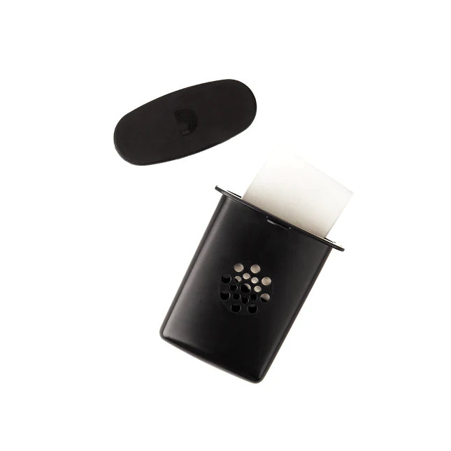 The image shows a straight mute for a brass instrument, likely a trumpet or cornet. It features a black oval top, a black conical body with circular ventilation holes, and a white cork or rubber seal to secure it inside the bell. This mute reduces volume and alters tone, producing a muffled sound while allowing some air to escape, making it useful for quiet practice in noise-sensitive settings.