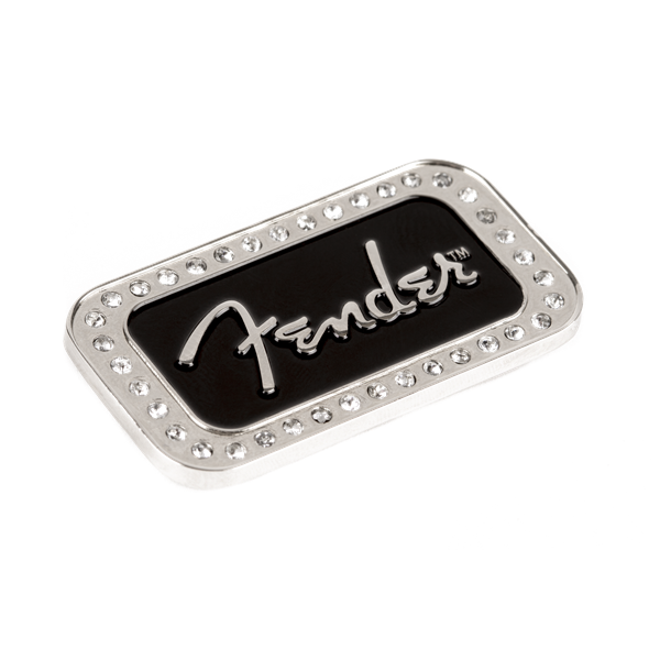 The image shows a Fender logo badge, a decorative metal emblem featuring the iconic silver "Fender" script on a black background. It is bordered by small metallic studs or rivets. Typically used on guitar amplifiers, cases, or Fender gear, this high-quality badge highlights brand loyalty and adds a stylish, detailed finishing touch to musical equipment.