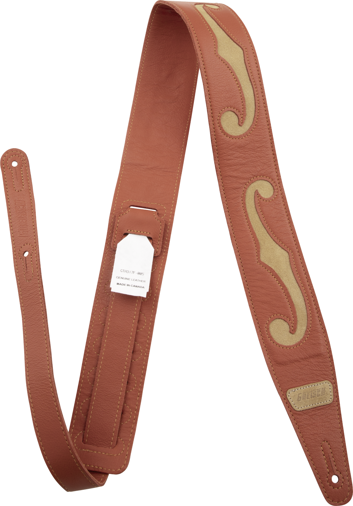 The image shows a high-quality leather guitar strap in rich brown/cognac with tan/cream decorative inlays forming a flowing, ornate pattern. It features detailed stitching, adjustable length with multiple holes, a small "GUITAR" brand label with "Made in Canada" marking, and professional hardware. This premium strap combines functionality with artisanal, handcrafted aesthetic appeal.