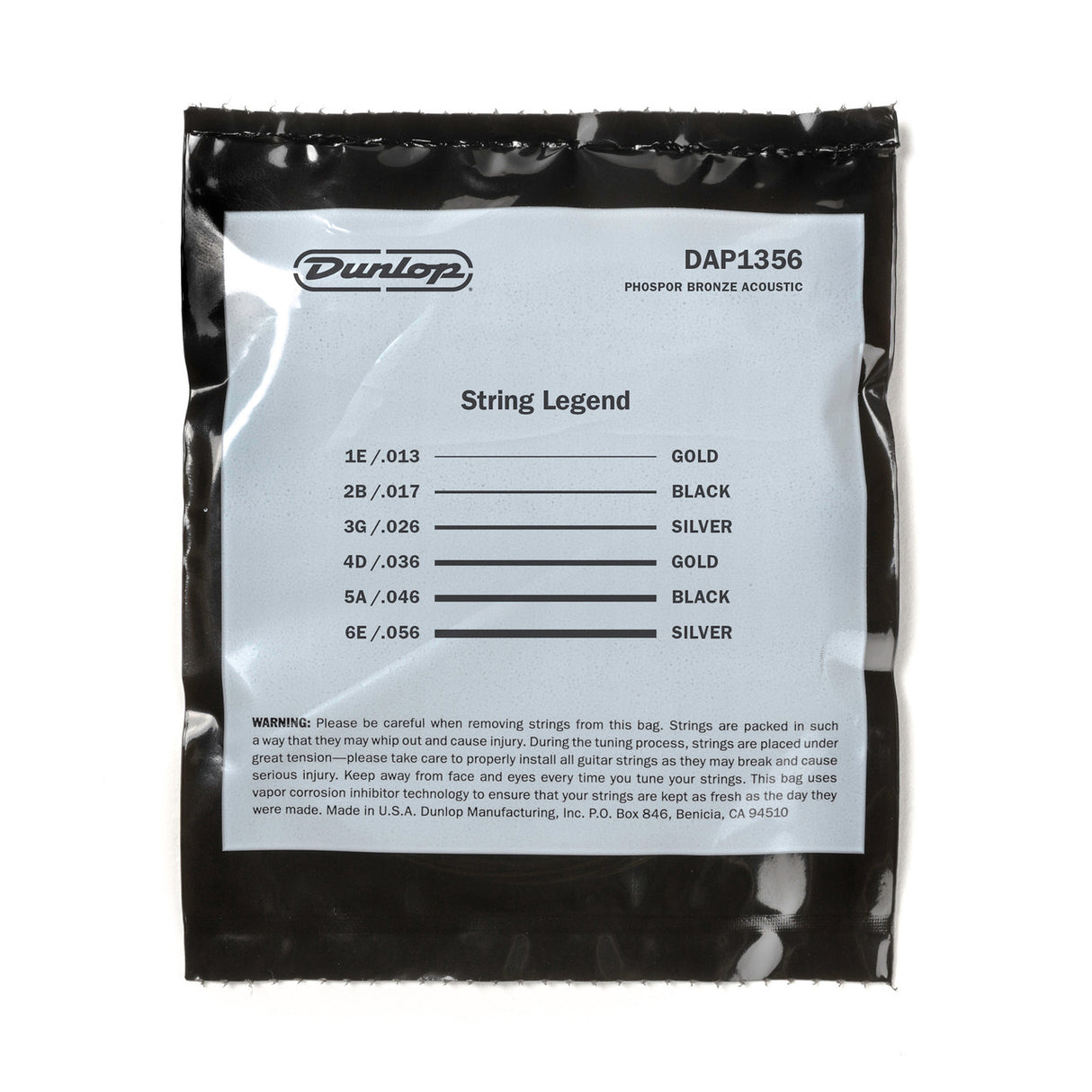 The image shows a package of Dunlop DAP1356 "String Legend" Phosphor Bronze acoustic guitar strings, medium-light gauge (13-56). The black sealed pack has a white label listing string gauges and colors: 1E/.013 (Gold), 2B/.017 (Black), 3G/.026 (Silver), 4D/.036 (Gold), 5A/.046 (Black), 6E/.056 (Silver). It includes safety info and features vapor corrosion inhibitor technology. Made by Dunlop in Benicia, California.