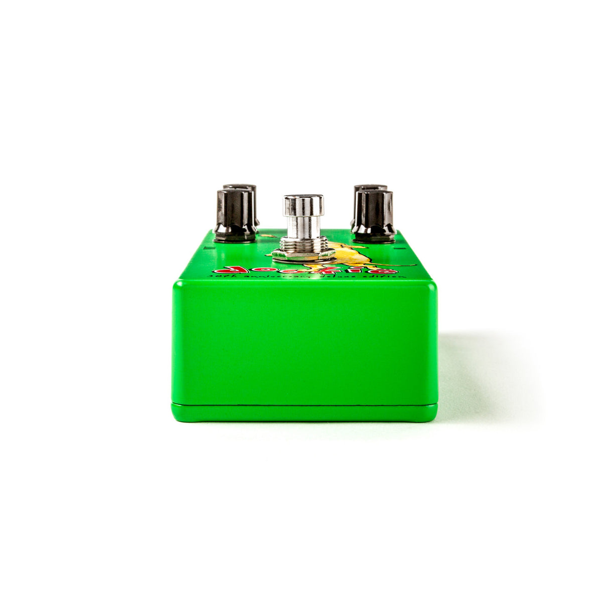 The image shows a bright green guitar effects pedal with a classic stompbox design. It features a metal enclosure, two side input/output jacks, a central silver control knob, and colorful graphics on top. This compact rectangular pedal is likely an overdrive or distortion unit used to add gain and saturation to an electric guitar’s tone, commonly found in boutique or specialty pedal markets.