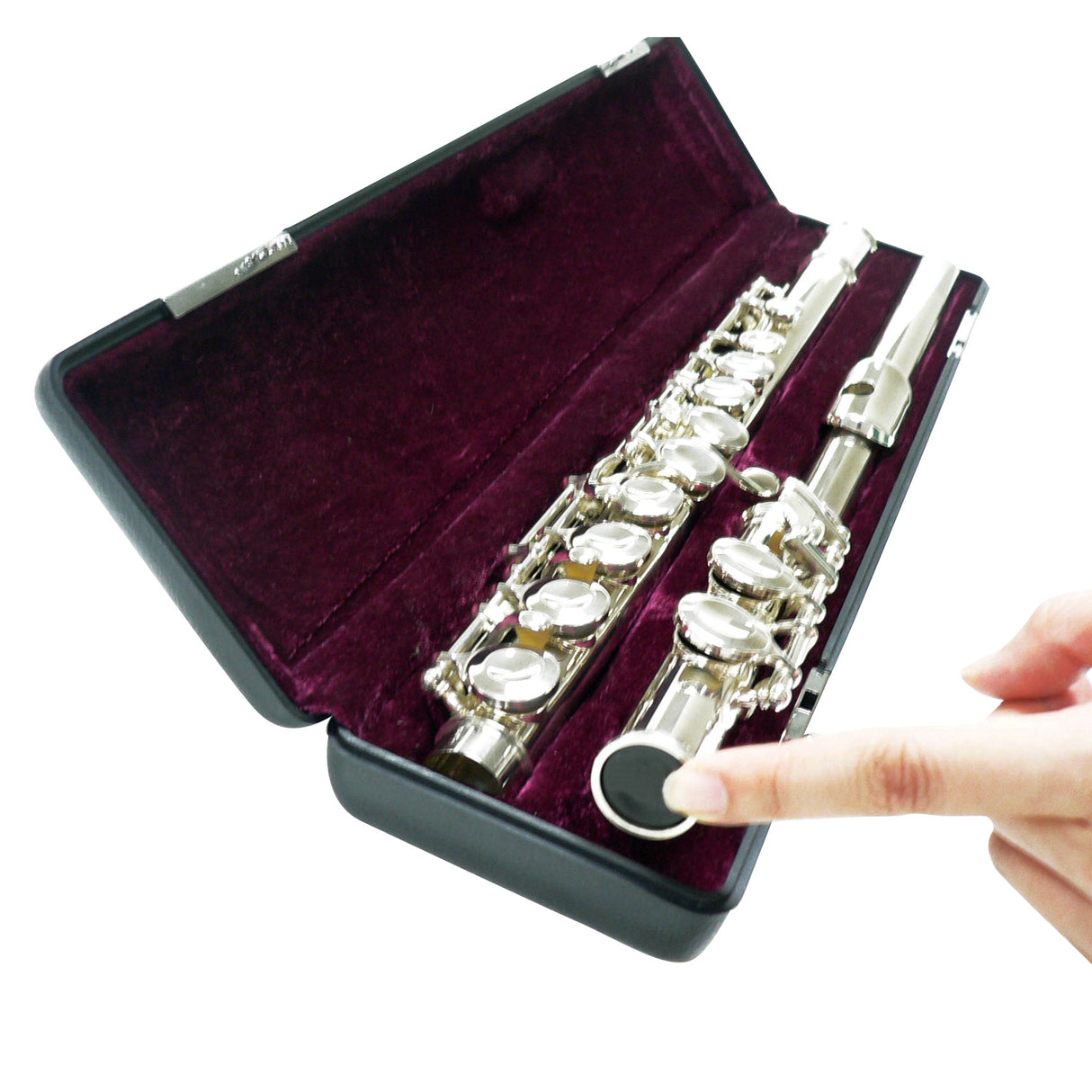 A finger pointing to a silver flute in a case with a folded up stand being stored inside