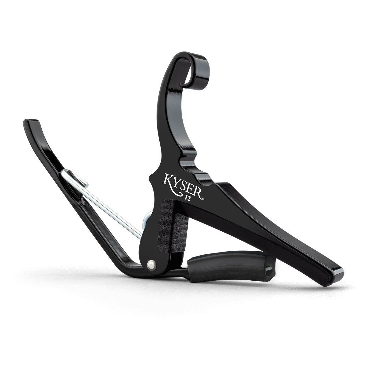 The image shows a KYSER spring-loaded quick-change guitar capo with a sleek black metal frame. It features a curved clamp, padded bar to press strings, a spring mechanism for one-handed use, and an ergonomic grip. Designed for steel-string acoustic or electric guitars, it raises string pitch by clamping across frets, enabling easy key changes while using familiar chords. KYSER is a trusted brand popular with guitarists.