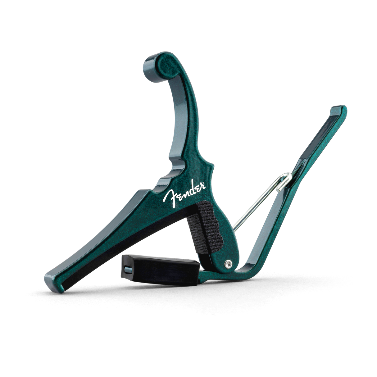 The image shows a teal Fender spring-loaded trigger capo with a white Fender logo. It features a padded black bar that clamps across the guitar fretboard and a curved handle for easy one-handed use. This sleek capo allows guitarists to change keys quickly while maintaining familiar chord shapes, combining functionality with Fender’s classic design, and is popular for acoustic playing.