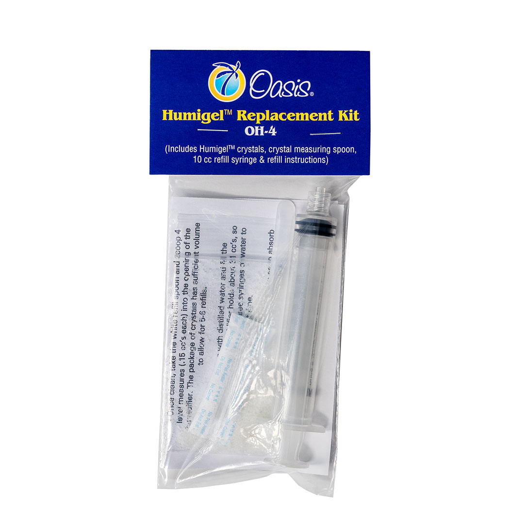 The image shows an Oasis Humigel™ Replacement Kit OH-4, a humidity control accessory for wooden musical instruments like guitars. The kit includes Humigel™ crystals, a measuring spoon, a 10cc refill syringe, and instructions. It helps maintain proper moisture levels to protect instruments from damage caused by dry conditions, such as cracking or warping, ensuring their longevity.