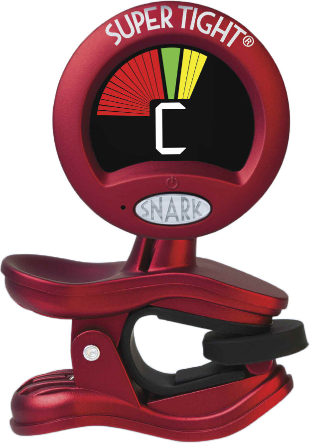 The image shows a red Snark "Super Tight" clip-on chromatic guitar tuner attached to a headstock. Its display features a central "C" note with a multicolored arc indicating flat, in tune, or sharp. The spring-loaded clip secures the tuner firmly. Designed for precise vibration-based tuning, it’s a popular, reliable tool for quickly tuning guitars and other stringed instruments, even in noisy settings.
