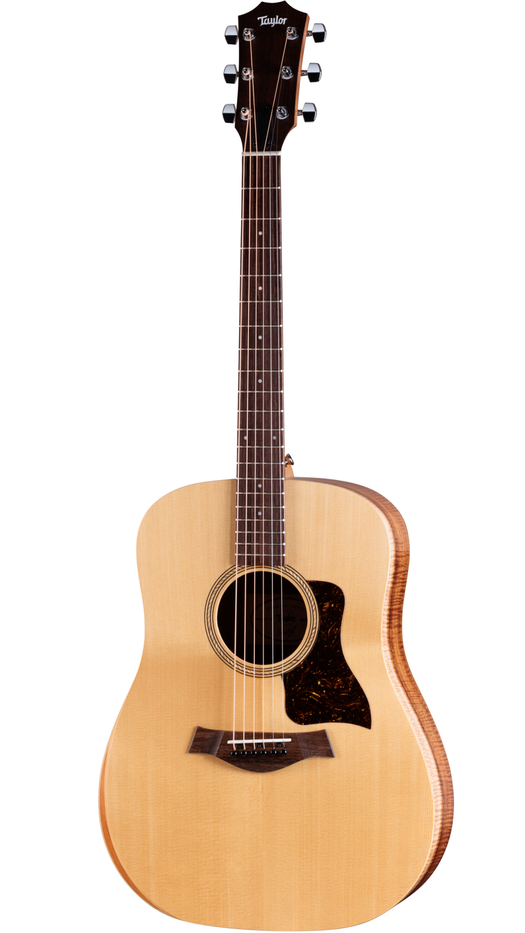 The image shows a Taylor acoustic steel-string guitar with a natural spruce top, darker wood back and sides, and a dreadnought body shape. It features chrome tuning pegs, a dark wood bridge, tortoiseshell pickguard, and a round soundhole with a decorative rosette. The neck has fret markers on dark wood. This well-crafted instrument reflects Taylor’s high-quality finish and design, suitable for both amateur and professional players.