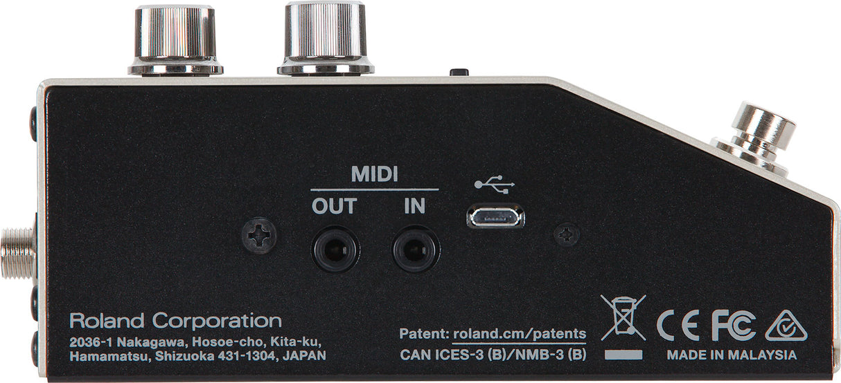 The image shows the back panel of a Roland audio interface featuring MIDI IN/OUT (5-pin DIN), USB and micro-USB ports, and audio input/output connections. It has a compact black design with silver knobs, marked with Roland branding, "Made in Malaysia," regulatory logos (CE, FCC), and patent info. This device connects MIDI instruments and audio sources to computers, ideal for musicians and producers bridging traditional gear with modern setups.