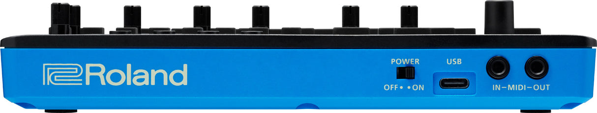 The image shows a bright blue Roland electronic music device, likely a synthesizer or keyboard workstation. It features six black rotary knobs, a power switch, a USB port, and two MIDI ports labeled "IN-MIDI-OUT." The professional design suggests use for music production, live performance, and sound design. Roland is a reputable brand known for electronic instruments with modern connectivity options.