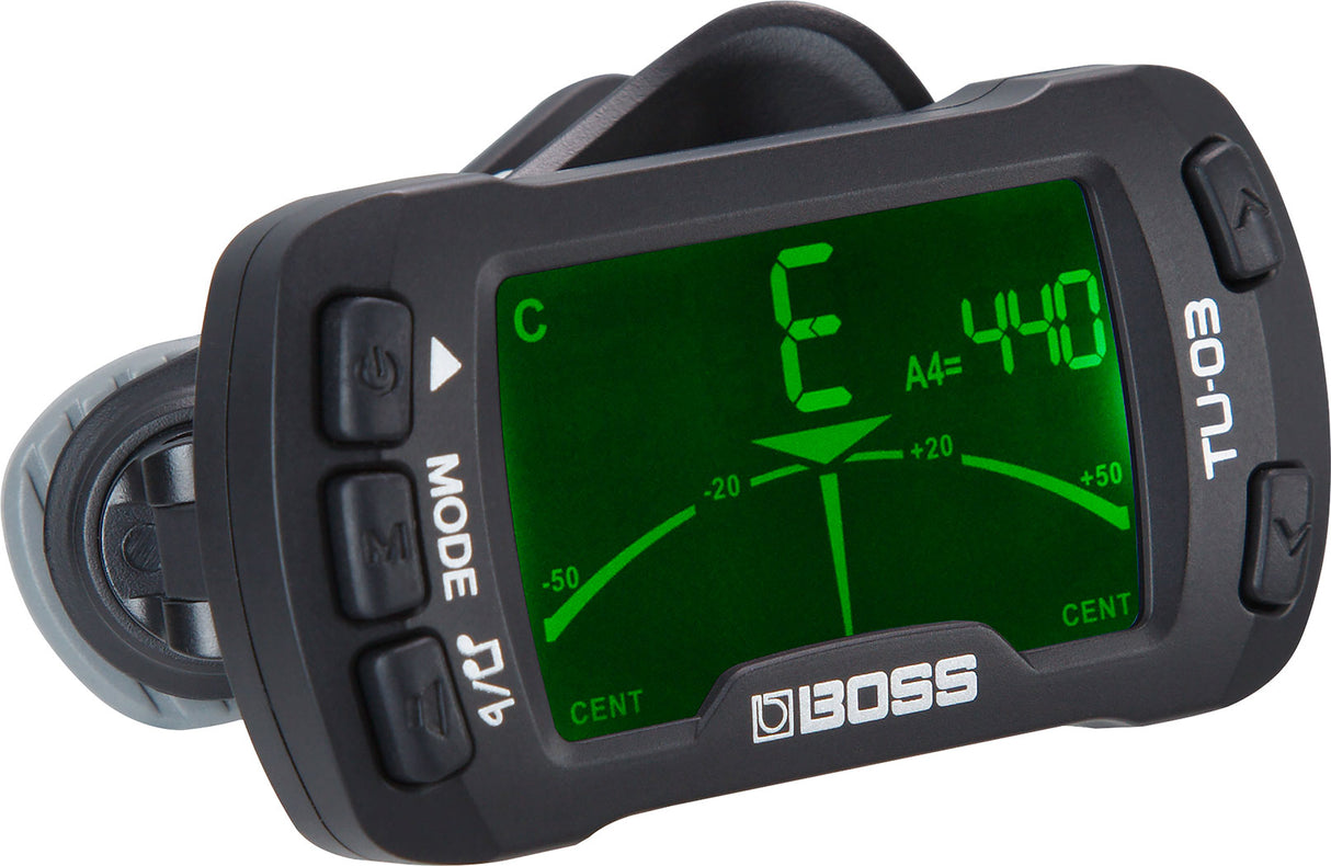 The image shows a BOSS TU-30 clip-on tuner with a bright green LCD displaying a "C" note and "A4=440" reference. It has a needle tuning meter centered at zero cents, multiple control buttons, and a black clip for attaching to instrument headstocks. Known for accurate vibration detection, it’s popular among guitarists and bassists for quick tuning in noisy settings.