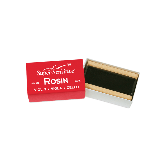 The image shows a block of "Super-Sensitive ROSIN" for violin, viola, and cello, labeled as the dark variety (No. 912). The rosin, dark amber or black in color, is housed in a small wooden or cardboard holder inside a red and white box. Rosin is essential for string instruments, applied to bow hair to create friction needed for sound when playing with a bow.