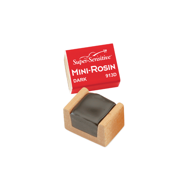The image shows a Super-Sensitive Mini-Rosin model 913D in dark rosin, housed in a small wooden case. Dark rosin is favored for lower-pitched instruments like cellos and basses due to its softer, grippier texture. This compact size is ideal for musicians seeking a portable rosin cake to apply to bow hair, enhancing friction and sound production on string instruments like violins, violas, cellos, and basses.