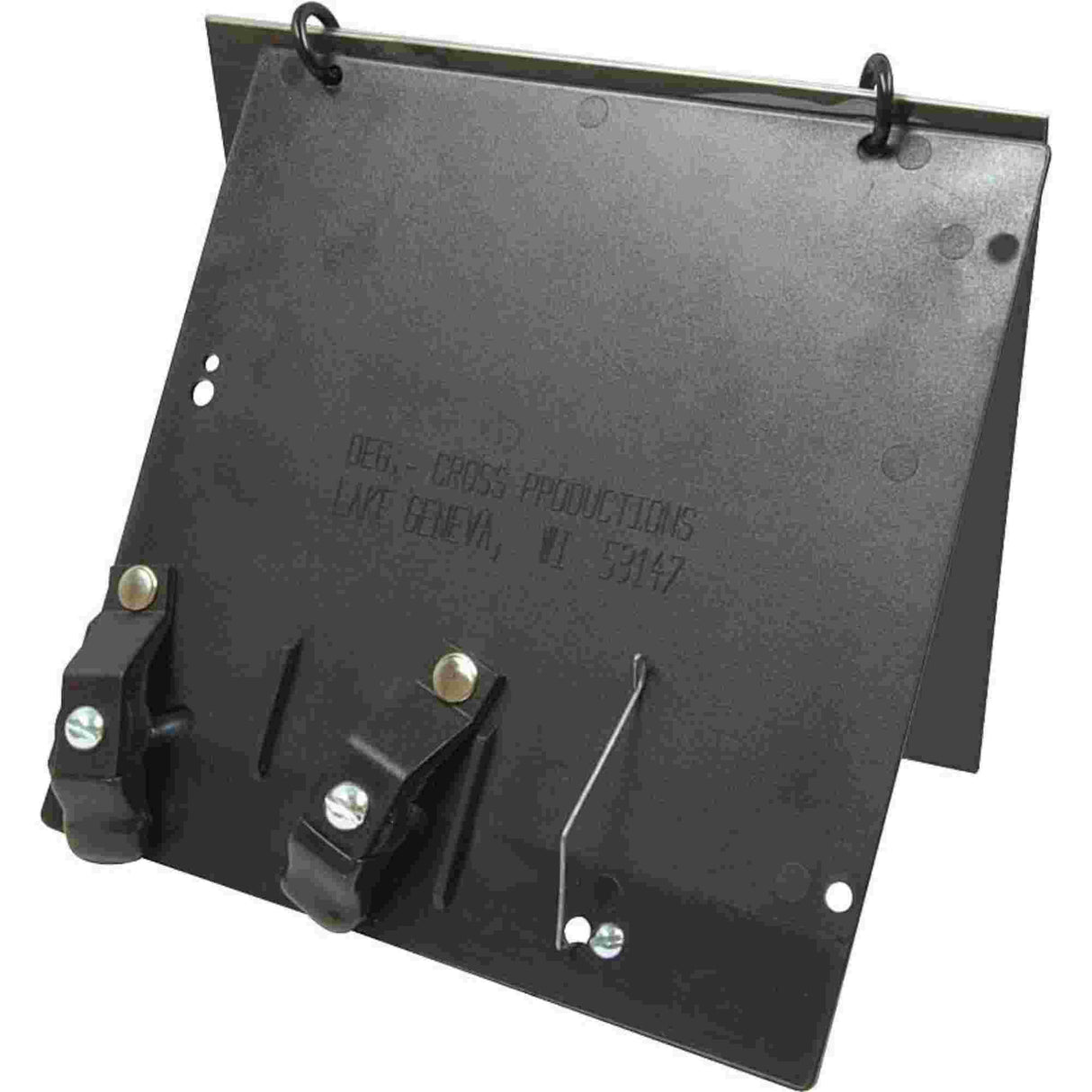 The image shows a black metal music sheet holder attachment with mounting rings for a stand. It features a flat tray for sheet music, two clamps at the bottom to secure pages, and multiple holes likely for adjustability or weight reduction. Embossed text on the surface hints at the manufacturer. This accessory helps musicians keep sheet music stable, especially outdoors, preventing pages from falling or blowing away.