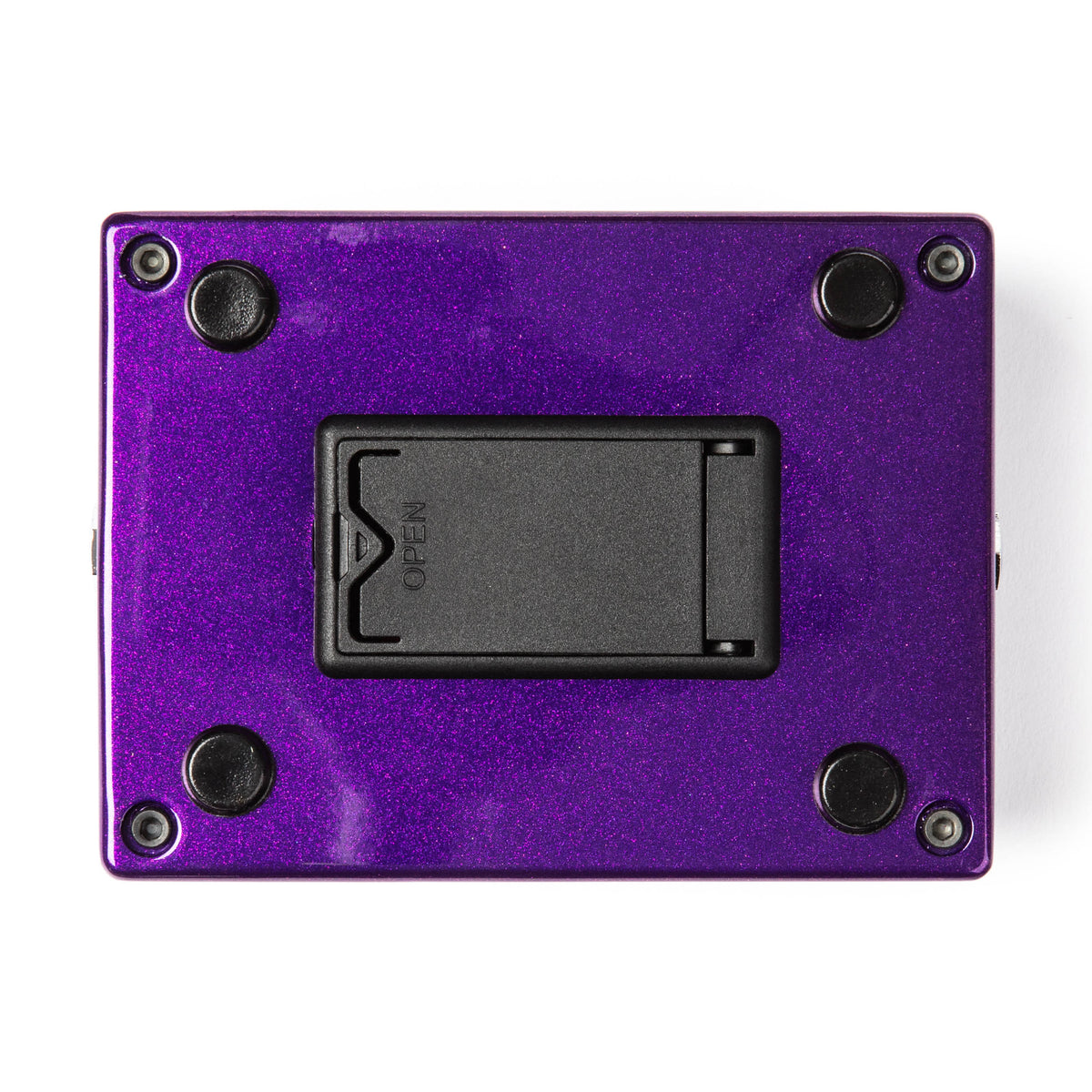 The bottom of a MXR bass pedal with a metallic purple finish and battery compartment.