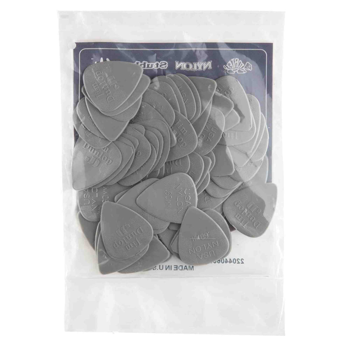 The image shows a clear package containing multiple gray Dunlop Nylon Standard guitar picks. The Dunlop logo is visible on the packaging and embossed on each pick. These picks are popular among guitarists for their durability and comfort, used for plucking or strumming guitar strings. Dunlop is a well-known maker of guitar accessories.