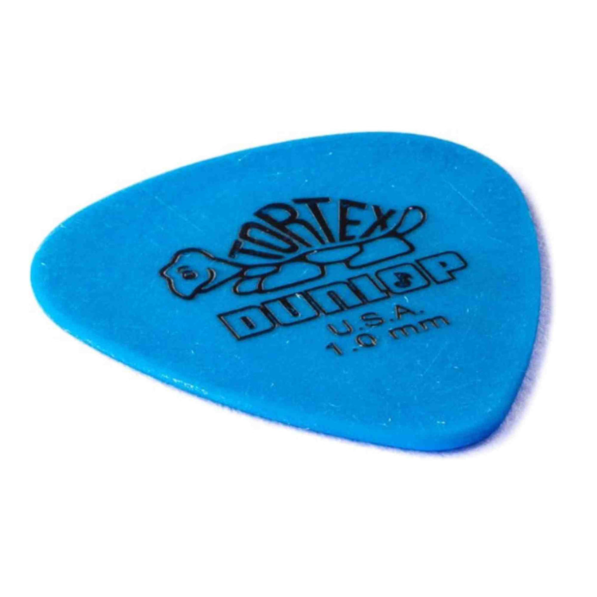 The image shows a blue Dunlop Tortex guitar pick with a teardrop shape and the Dunlop turtle logo. It is marked "1.0 mm" for thickness and "USA" for manufacture. Made from durable synthetic material, this medium-heavy pick offers a balance of flexibility and precision. The blue color is part of Dunlop’s system to identify pick gauges by color.
