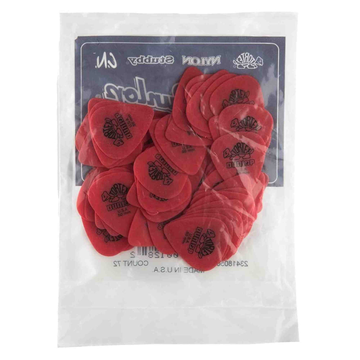 The image shows a clear plastic package of red guitar picks with the Dunlop logo, sealed with a dark header card displaying the brand. These picks, also called plectrums, are essential for strumming or plucking guitar strings. The pack contains multiple picks, typical for retail, providing backups for guitarists who often lose or drop them during play.