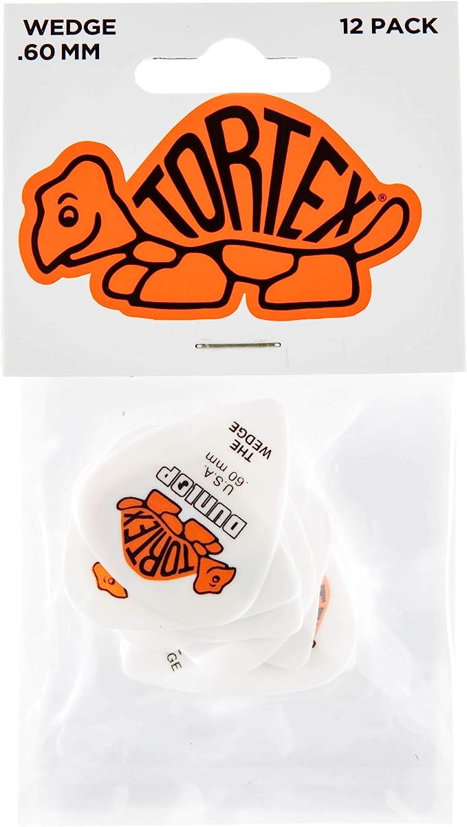 The image shows a package of 12 Dunlop Tortex wedge-shaped guitar picks, 0.60mm thick. The packaging features Dunlop’s orange turtle logo with "TORTEX" on the shell and a clear window revealing a white pick inside. These popular picks are known for their durability, tactile feel, and medium thickness, offering more surface area and control compared to standard picks, suitable for various playing styles.