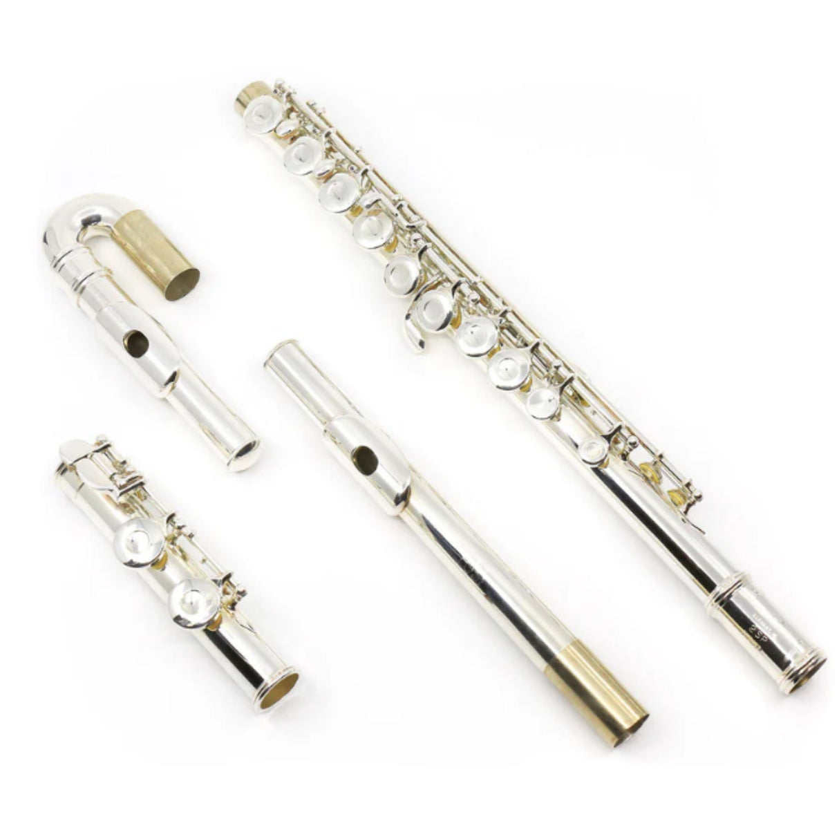 The image shows a disassembled silver-plated flute with gold accents, separated into its three main parts: the curved head joint with the embouchure hole and lip plate (upper left), the longest body joint with most keys and tone holes (right), and the short foot joint with final keys (lower left). Visible keys, springs, and rods highlight the instrument’s intricate mechanism and craftsmanship.