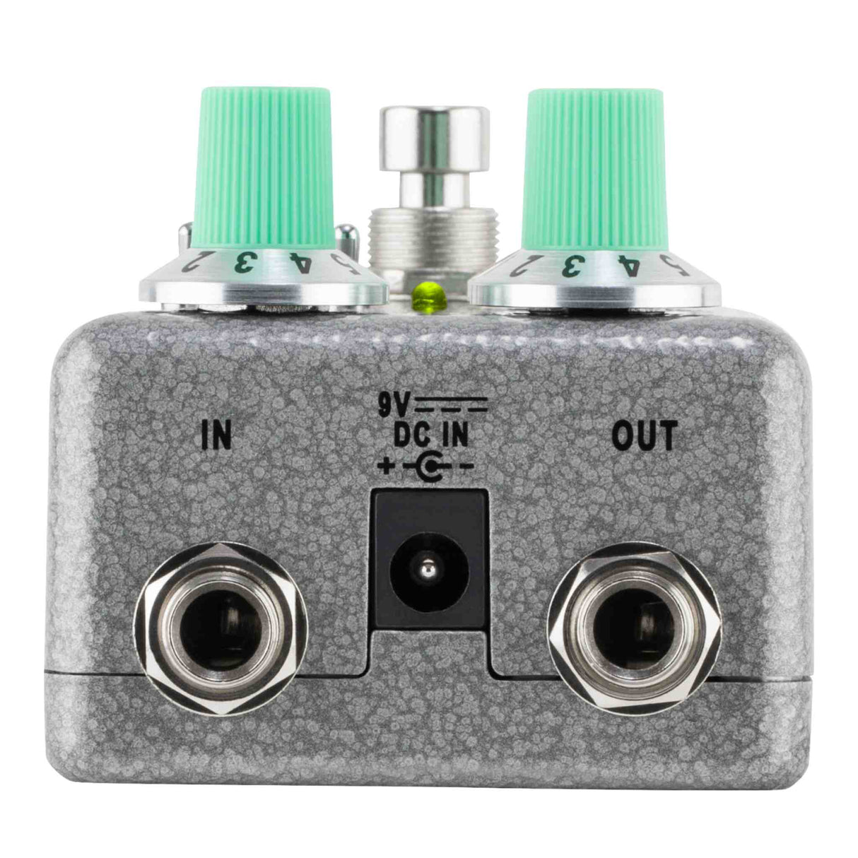 Guitar effects pedal with green knobs and metal connectors on a white background