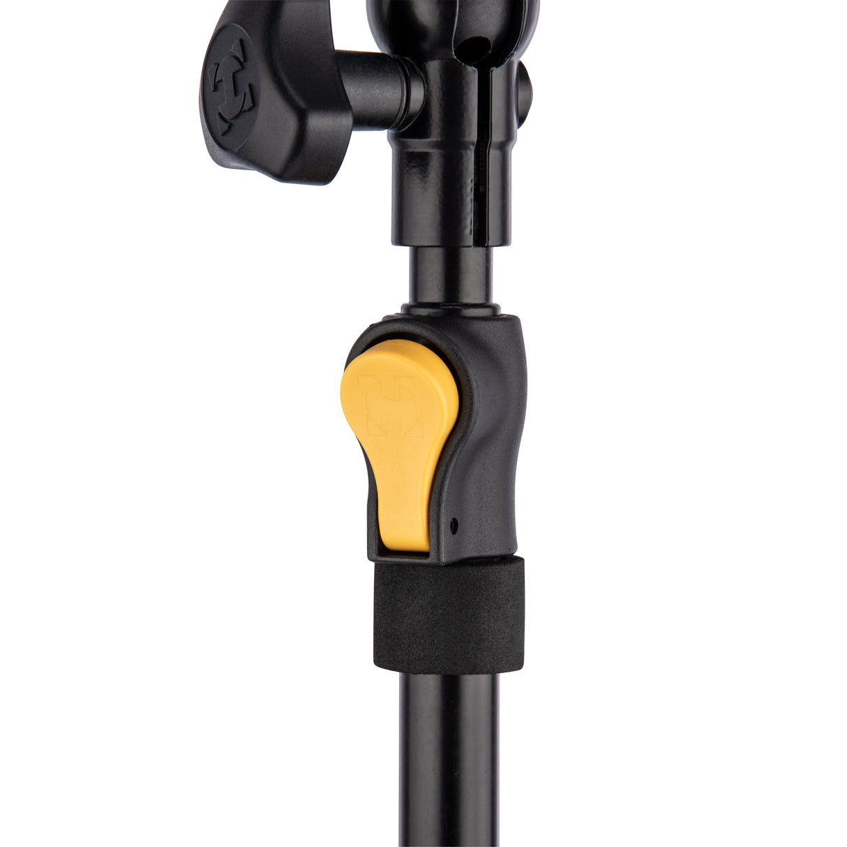 Close-up of a black and yellow adjuster for a light and camera stand on a white background