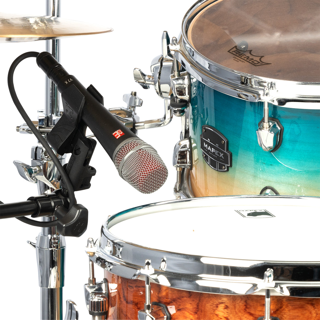 A black microphone stand attachment holder with mic hovering over a drumset
