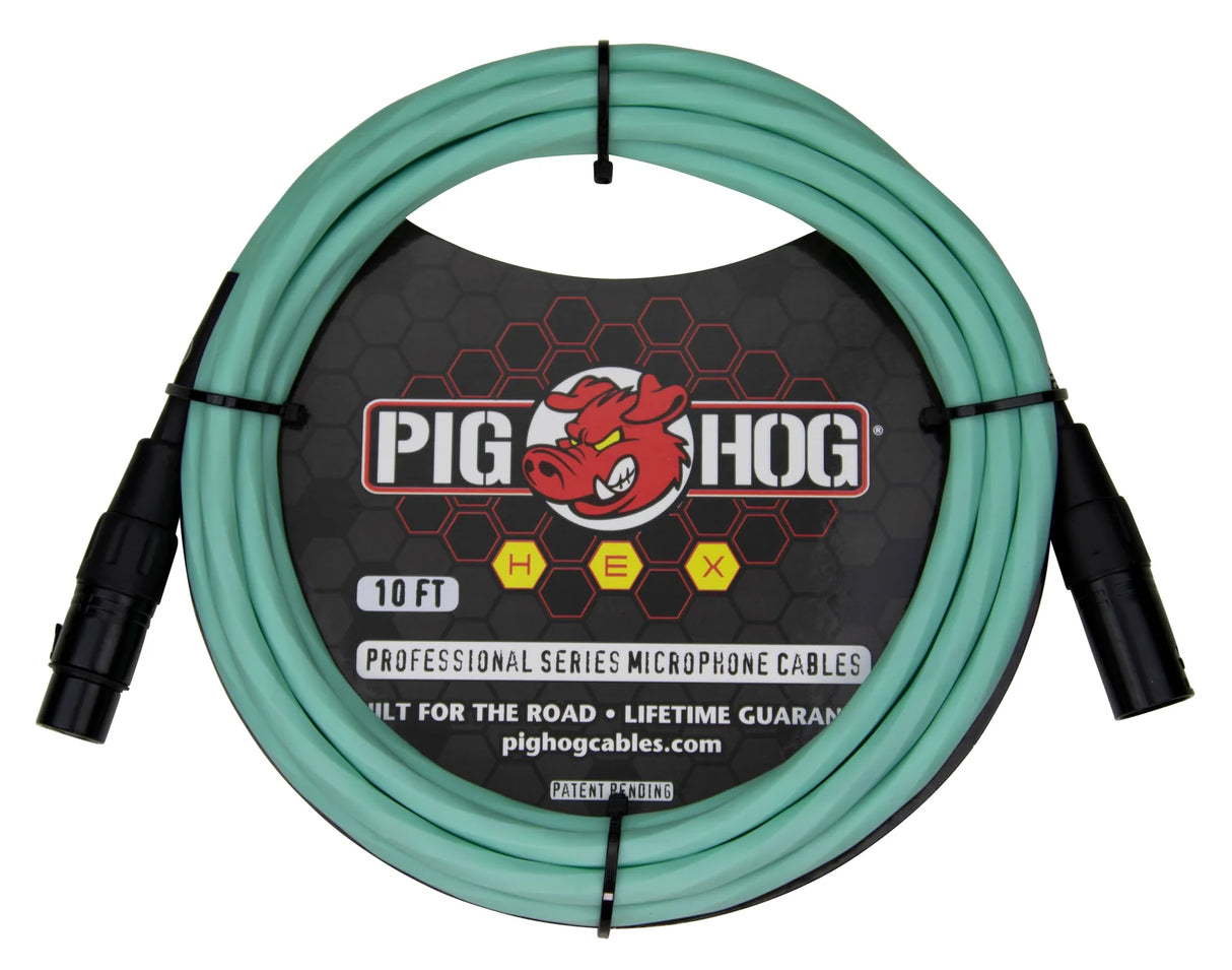 The image shows a 10-foot Pig Hog professional microphone cable from the HEX series, featuring seafoam green/turquoise shielding and black male and female XLR connectors. It displays the Pig Hog red pig logo and is marketed as "built for the road" with a lifetime guarantee. This standard XLR cable connects microphones to audio equipment and is easily identifiable by its distinctive color.