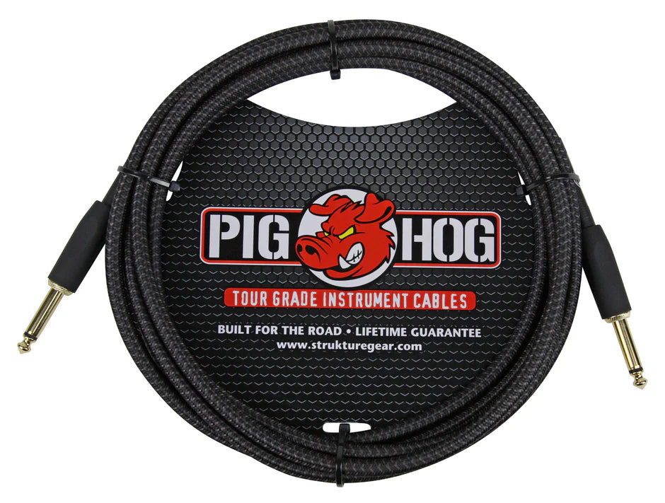 The image shows a Pig Hog tour grade instrument cable with 1/4" mono jack plugs on both ends, featuring a black braided outer jacket for durability. It displays the red pig mascot logo, "Built for the road" and "Lifetime guarantee" claims, and the website struktuegear.com on the packaging. This professional-quality cable is designed for electric guitars and basses, ensuring reliable signal transmission during live performances.