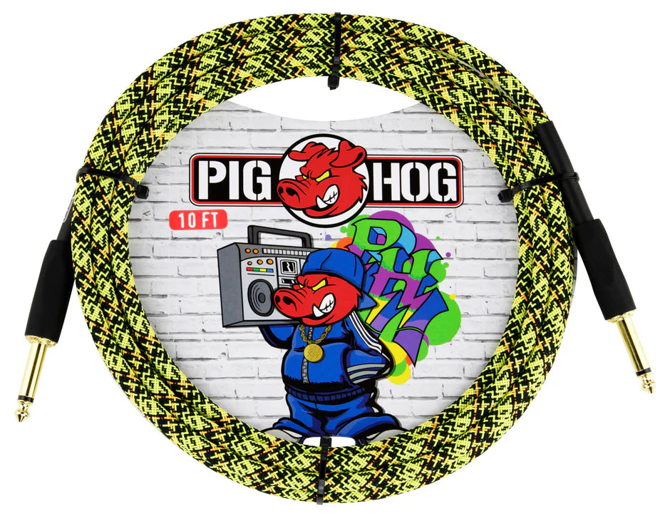 The image shows a Pig Hog 10-foot instrument cable with a yellow and black woven fabric cover and gold-plated 1/4" connectors. The packaging features the Pig Hog logo with a red pig mascot in hip-hop attire holding a boombox. Known for durability and affordability, this cable is popular among guitarists and bassists, offering protection and style for connecting instruments to amps and pedals.