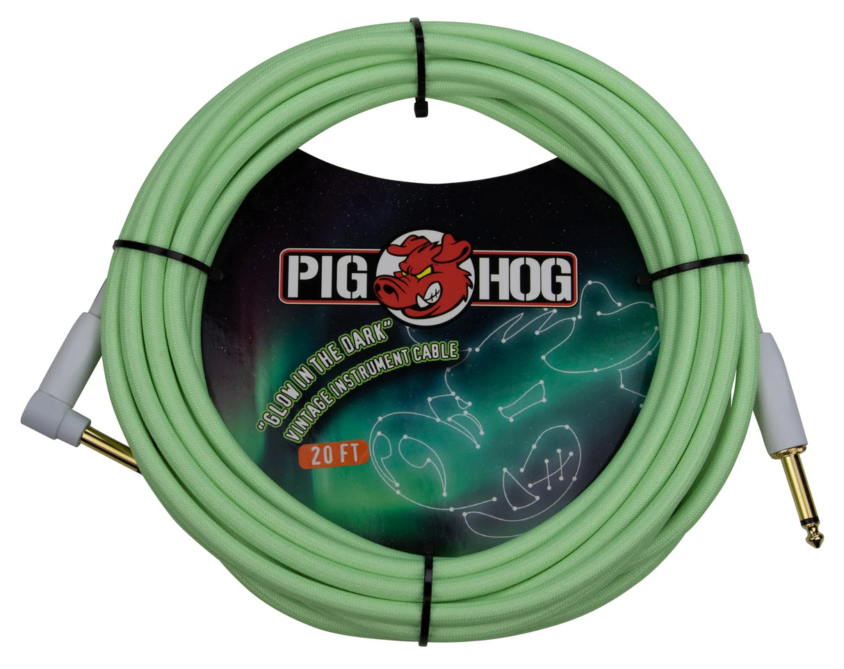 The image shows a coiled 20-foot Pig Hog "Glow in the Dark" instrument cable with a light green/mint color. It features gold-plated 1/4" connectors with white clear housings, and the Pig Hog red pig logo on the packaging. Designed for guitars and other instruments, the durable cable’s glow-in-the-dark feature helps musicians locate it easily in low-light settings.
