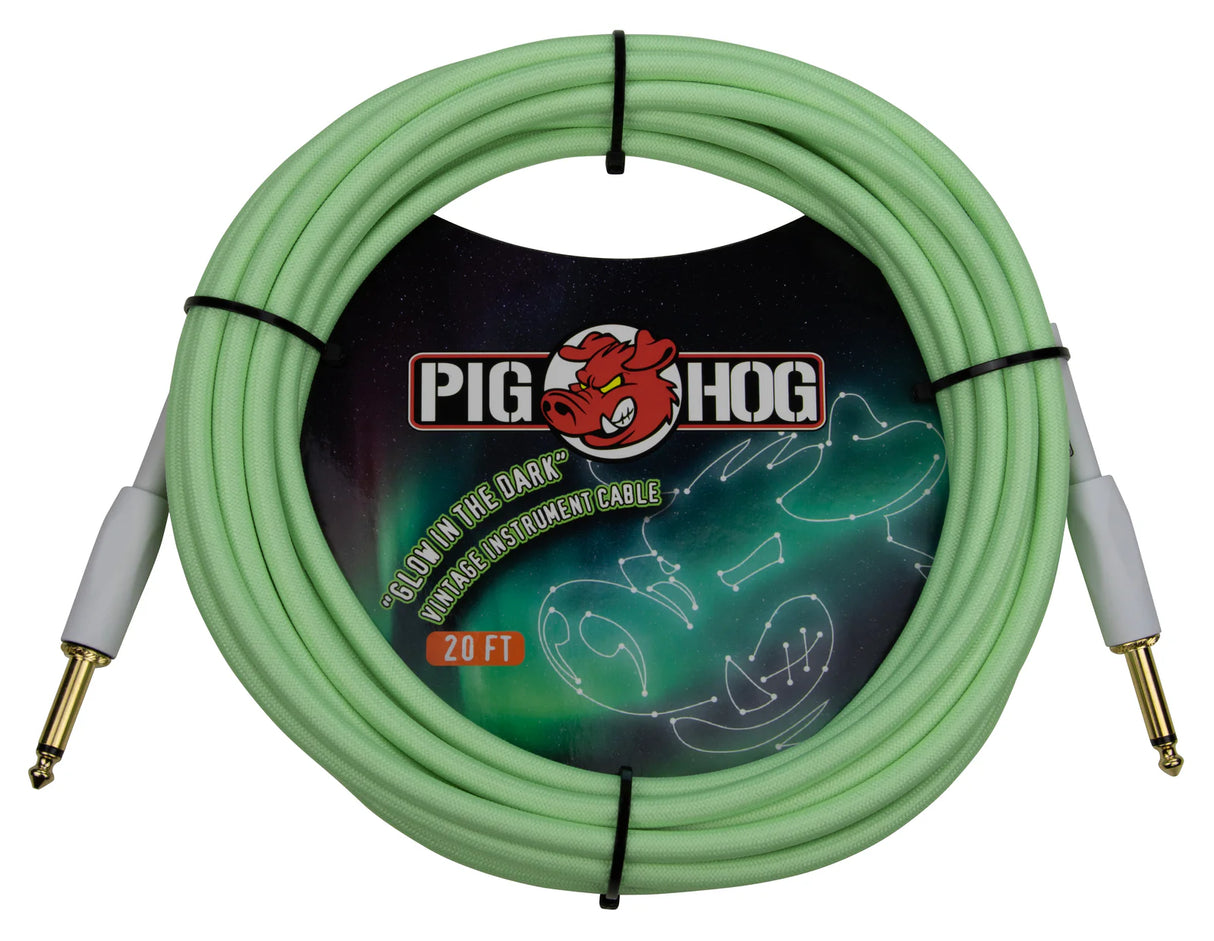 The image shows a 20-foot Pig Hog vintage instrument cable in seafoam green with gray housings. It features 1/4" straight plugs with gold-plated tips and a glow-in-the-dark design. Known for durability and low noise, this cable is ideal for guitars and basses. The distinctive color and glow feature help musicians locate it easily on dark stages, combining functionality with unique vintage style.