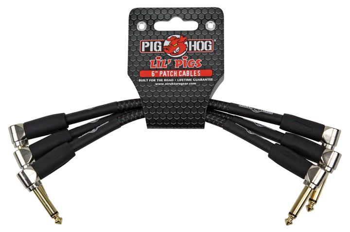The image shows a set of Pig Hog "Lil' Pigs" 6-inch patch cables with black sheathing and gold-colored right-angled 1/4-inch connectors. These short cables connect guitar effects pedals on a pedalboard, helping musicians chain multiple effects neatly. Known for their durable, professional-grade build, Pig Hog cables are ideal for live and studio use, offering reliable performance in compact pedal setups.