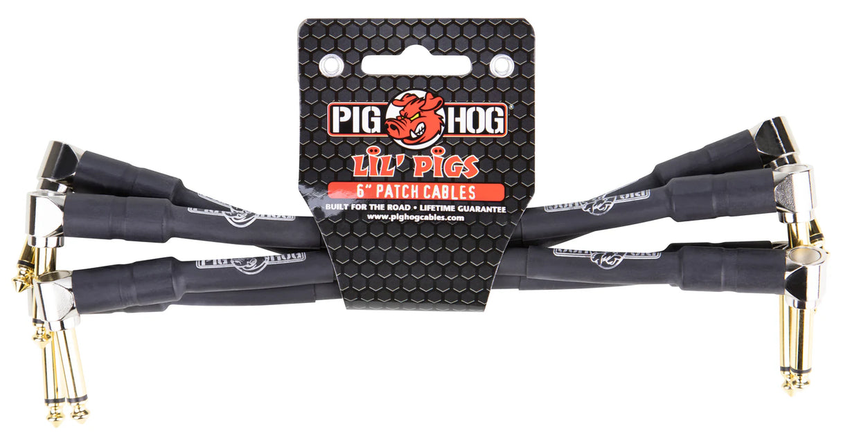 The image shows a set of Pig Hog "Lil' Pigs" 6-inch audio patch cables with right-angle gold-plated plugs and black jackets with branding. These short, durable cables are designed for connecting guitar pedals, studio gear, and other audio devices in compact setups. Packaged for musicians and audio pros, they feature a "lifetime guarantee" and are built for reliable, road-ready performance.
