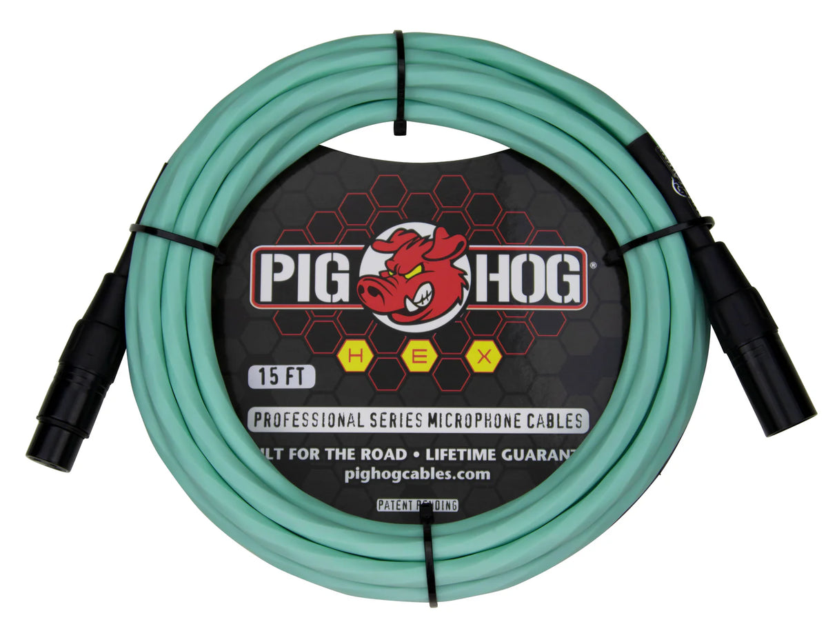 The image shows a 15-foot Pig Hog Professional Series XLR microphone cable with seafoam green/turquoise jacket and black metal connectors. It features male to female connectors, the red pig logo, yellow "HEX" badges, and "Built for the Road • Lifetime Guarantee" branding. Designed for professional audio use, this durable cable is ideal for microphones and audio equipment in live and studio settings.