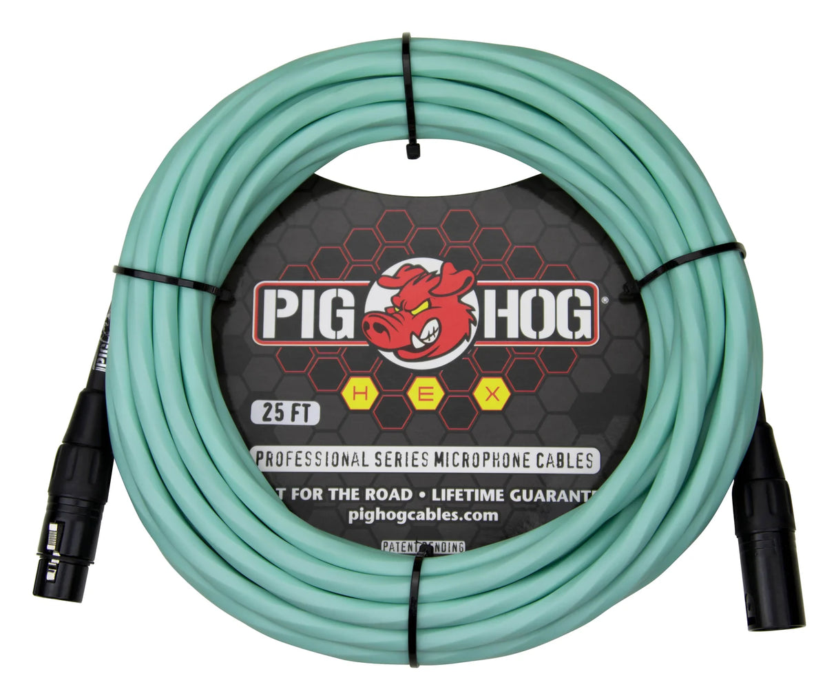 The image shows a 25-foot seafoam green Pig Hog HEX professional XLR microphone cable with black male and female connectors. It features the red pig mascot logo and packaging stating "built for the road" with a lifetime guarantee. Designed for connecting microphones to audio equipment, this durable, colorful cable is popular among musicians and sound engineers for easy cable management.