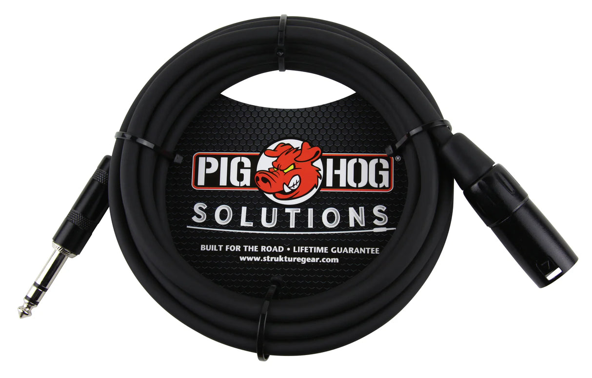 The image shows a black professional audio cable from Pig Hog Solutions with a 1/4" TRS connector on one end and an XLR connector on the other. It features the Pig Hog red pig logo and "SOLUTIONS" text. Labeled "Built for the Road" with a lifetime guarantee, this durable cable is used for connecting instruments, microphones, and audio gear. The packaging displays www.strukturegear.com, indicating it’s part of their professional audio lineup.