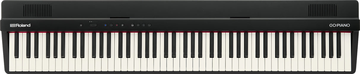 The image shows a Roland GO:PIANO digital keyboard with a full-size 88-key layout featuring traditional black and white keys. It has a sleek black body, the Roland logo on the left, "GO:PIANO" on the right, control buttons and indicators on the top panel, and ventilation grilles at both ends. This compact, portable digital piano is designed for beginners and musicians seeking an affordable, lightweight alternative to acoustic pianos.