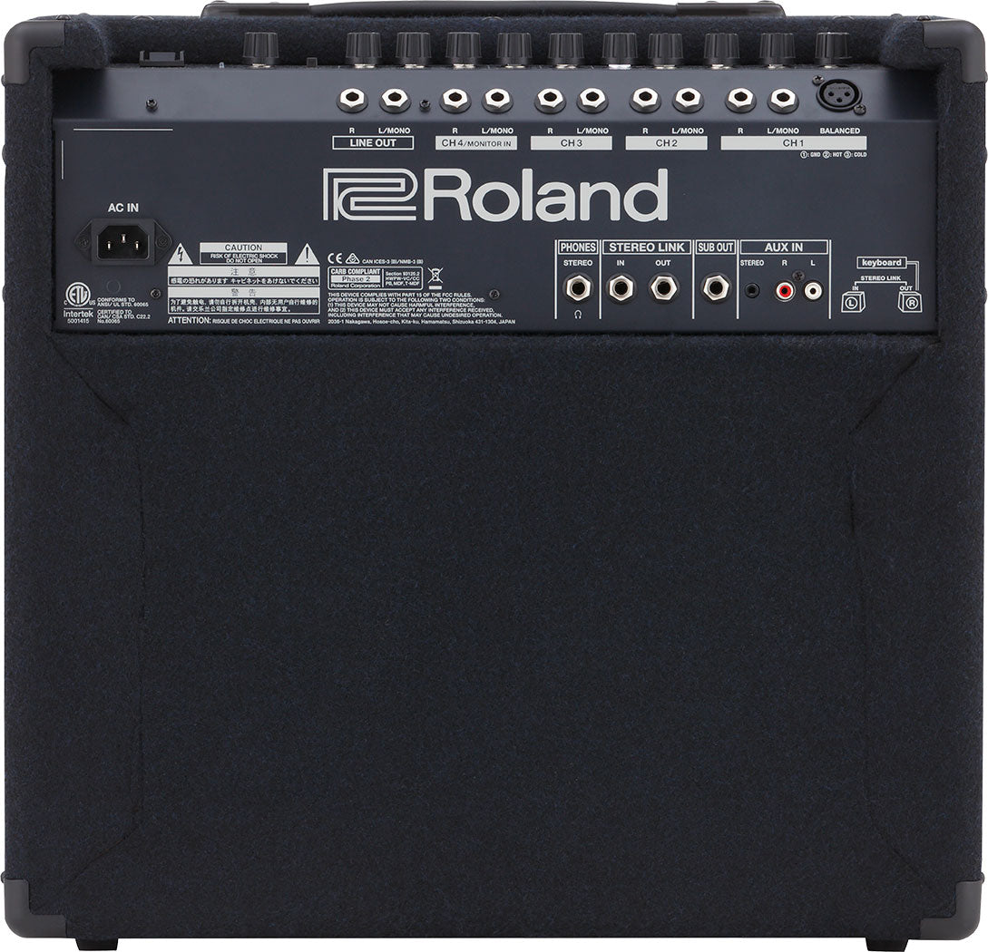 The image shows the back panel of a Roland keyboard amplifier or monitor speaker. It features multiple 1/4" inputs, XLR balanced output, stereo link, sub out, aux in, and a headphone jack. A row of control knobs is present for volume and EQ. There is a standard AC power inlet and the unit has a black textured finish with corner protectors, typical of professional audio gear.